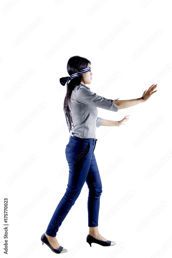 Businesswoman blindfolded with a tie on studio Businesswoman blindfolded with a tie on studio