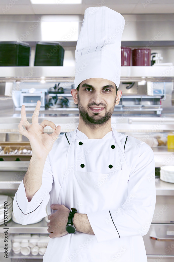 Arabian chef with OK sign in the kitchen