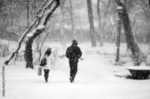 Snowing urban landscape with people passing by   © ileana_bt