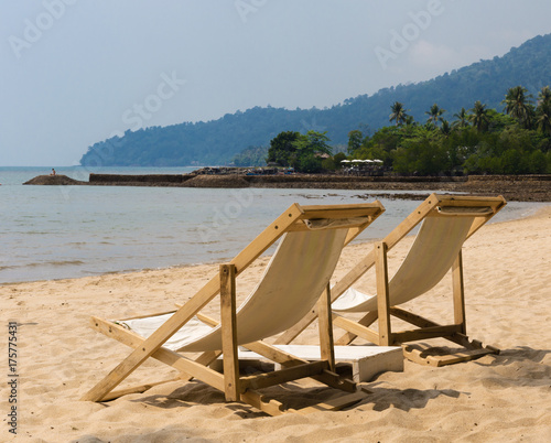 Two beach chairs on idyllic tropical sand beach.