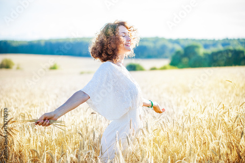 smiling happy woman in wheat field