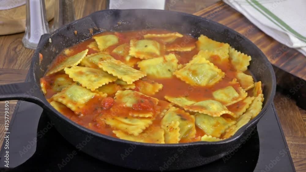 Tomato basil ravioli simmering in a cast iron skillet
Tomato basil ravioli simmering in a cast iron skillet