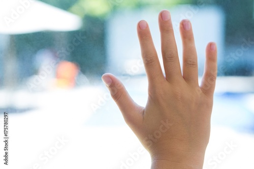 Close up of hand touching glass