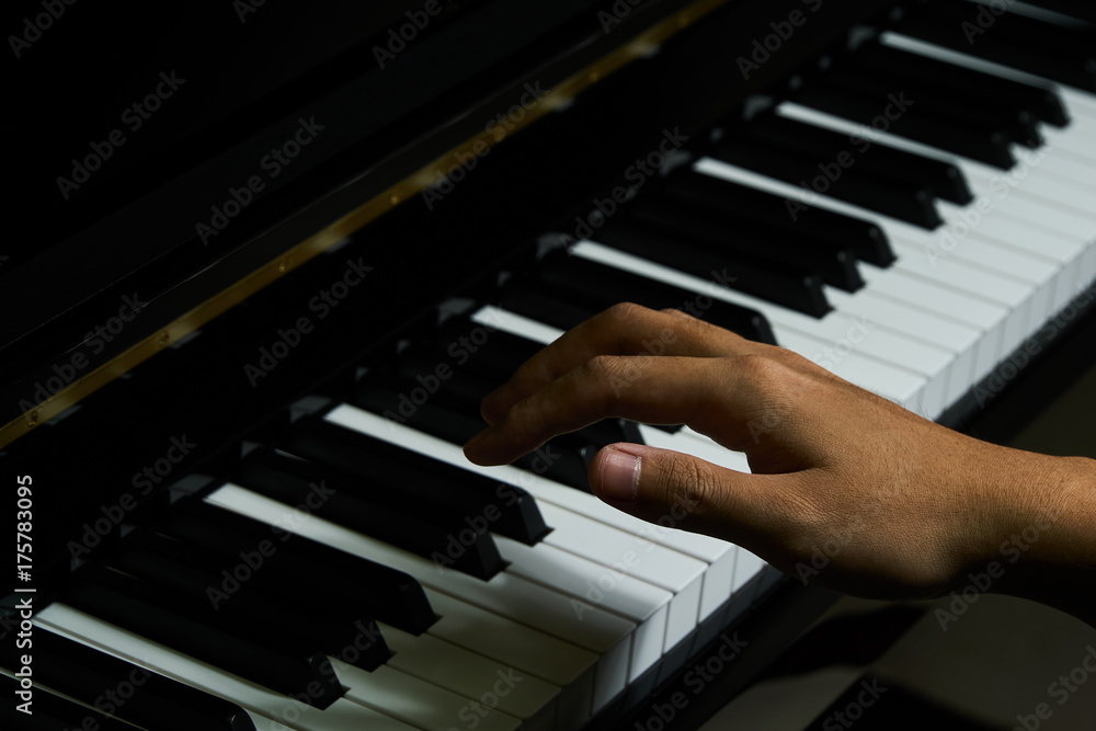 Fototapeta premium Playing piano in studio with close up shot