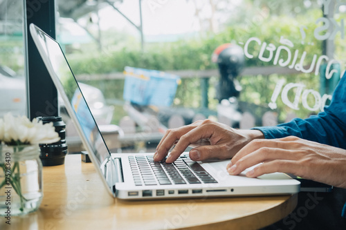 Hipster man using laptop photo