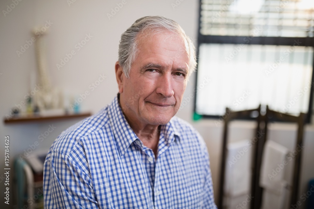 Portrait of senior male patient against window Portrait of senior male patient against window