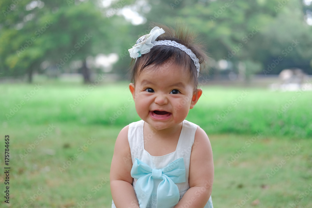 Asian Adorable baby girl playing in park. Beautiful smiling cute baby Asian Adorable baby girl playing in park. Beautiful smiling cute baby