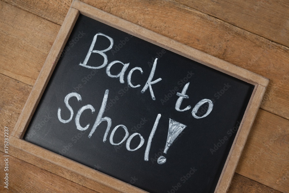 Fototapeta premium Slate with text on wooden table