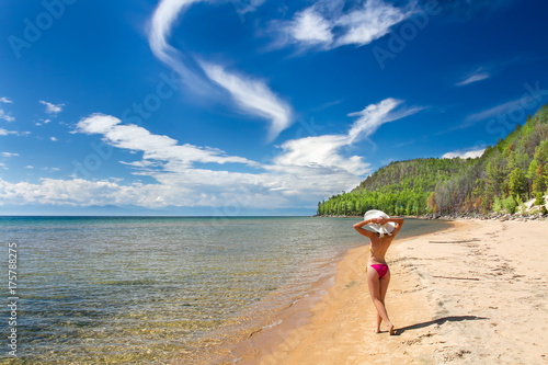 Canvas-taulu A girl on a sandy beach on a lake baikal