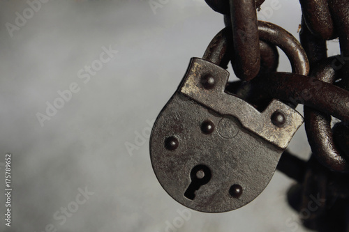 Old padlock locking a ohains