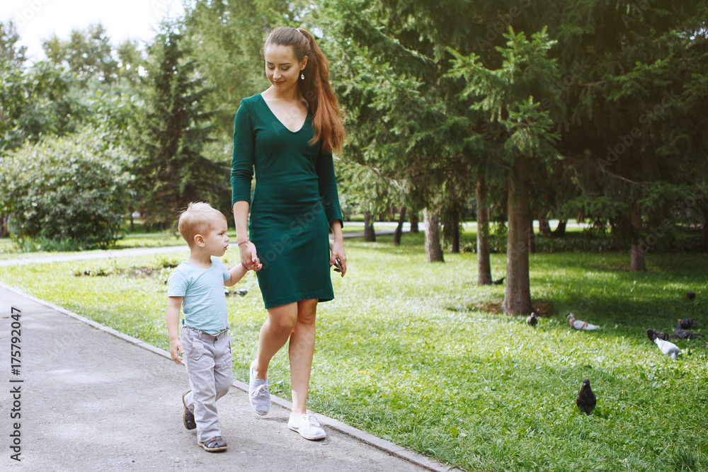 Young mother with little son having fun playing in the Park Young mother with little son having fun playing in the Park