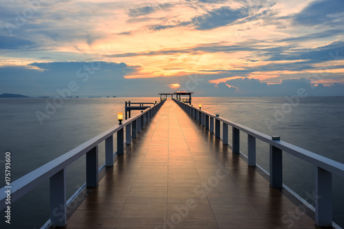 Wooded bridge in the port along sunrise.Wooden pier between sunset in Phuket, Thailand. Summer, Travel, Vacation and Holiday concept.