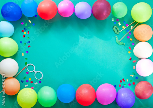 The decoration for the party. Festive turquoise background with multi colored balloons.