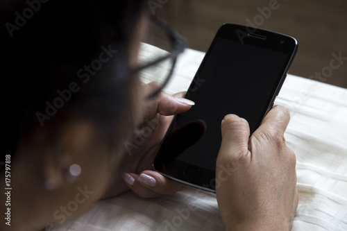 Female hand holding the smartphone Black color
