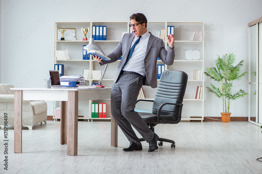 Businessman having fun taking a break in the office at work Businessman having fun taking a break in the office at work