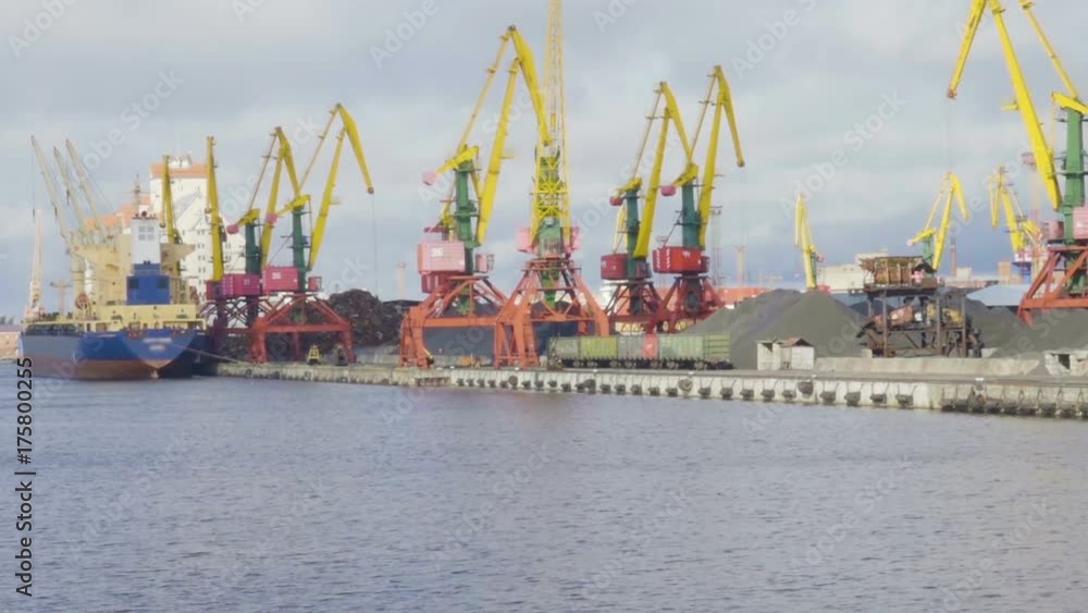 Cargo crane, freight train and coal in port. Cranes at the container port terminal. Scrap metal. Ship in the dock. Cargo crane, freight train and coal in port. Cranes at the container port terminal. Scrap metal. Ship in the dock.