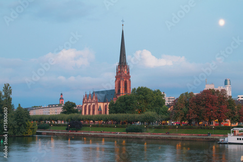 Evening embankment and church. Frankfurt am Main, Germany