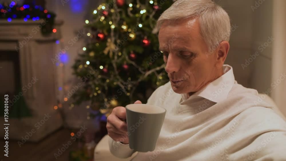 Pleasant aged man eating cookies at home Pleasant aged man eating cookies at home