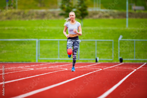 Young Female In Sportswear Running On Sports Tracks © kjekol