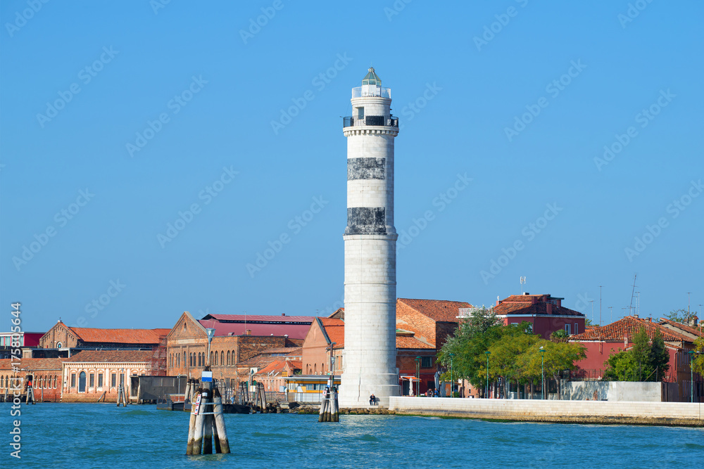 Lighthouse on the Murano island on a sunny day. Venice, Italy