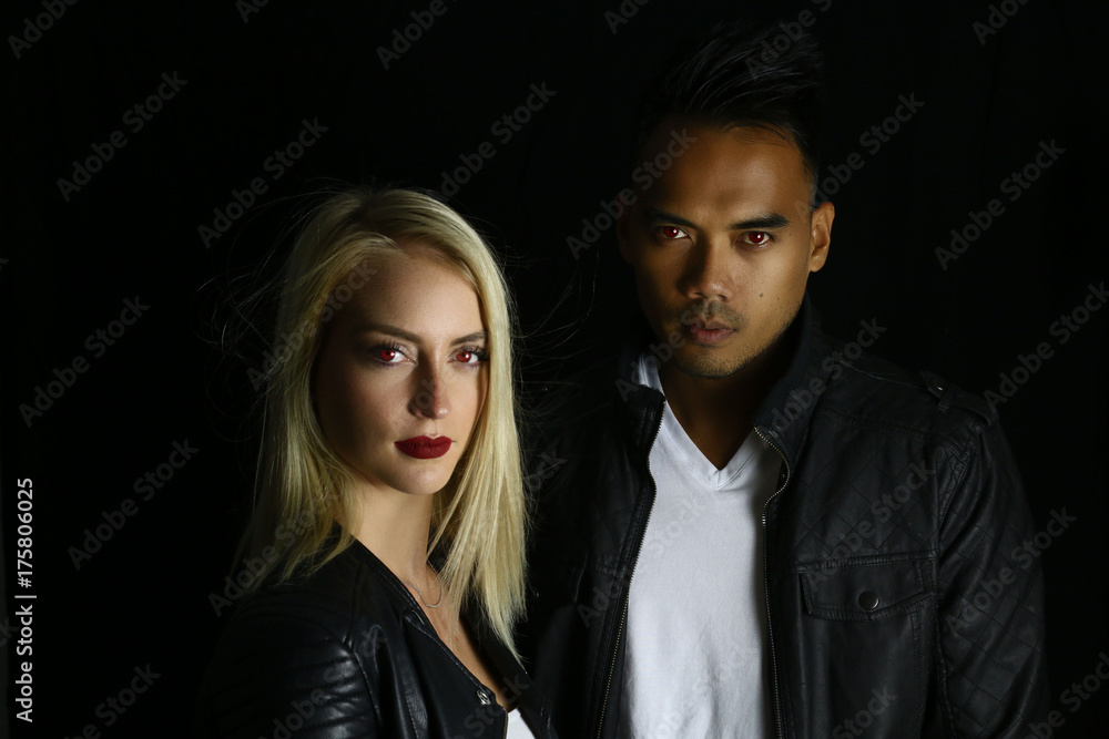 vampire couple posing on a black background vampire couple posing on a black background