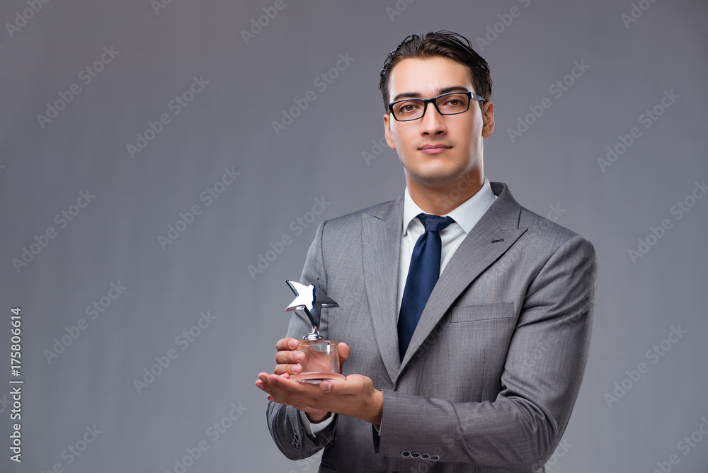 Businessman holding star award in business concept