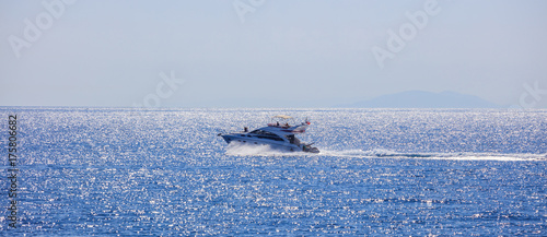People with high-speed boat in the sea.