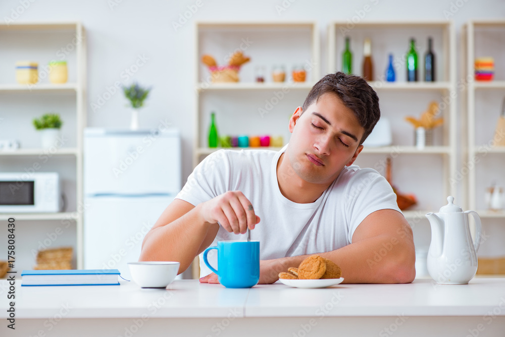Man falling asleep during his breakfast after overtime work Man falling asleep during his breakfast after overtime work