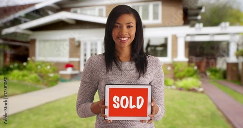 Wallpaper Mural Portrait of pretty black female holding sign advertising sold home Torontodigital.ca
