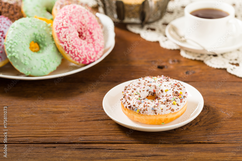 Colorful donuts on a wooden background. Colorful donuts on a wooden background.