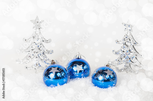 Blue Christmas balls and silver spruce with blue sparkling background. Festive winter and Finland 100  concept. Blue and silver xmas decoration with copy space.Copy space for text