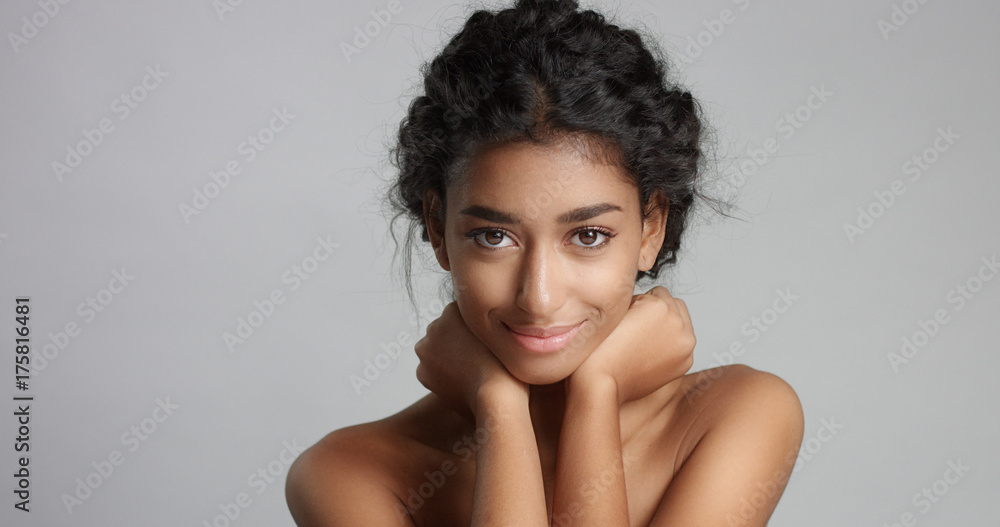 happy serene young woman with beautiful olive skin and curly hair ideal skin and brown eyes happy serene young woman with beautiful olive skin and curly hair ideal skin and brown eyes