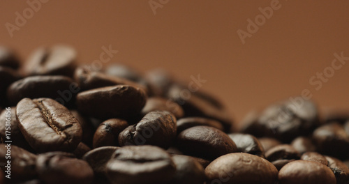 freshly roasted coffee beans isolated on brown. studio shoot