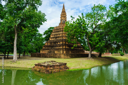 Beautiful ancient brick pagoda stay in Ayutthaya, Thailand. This have forest and blue sky in background.