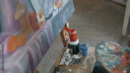 Caucasian artist painting a colourful picture of still life, close-up of indoor slow motion