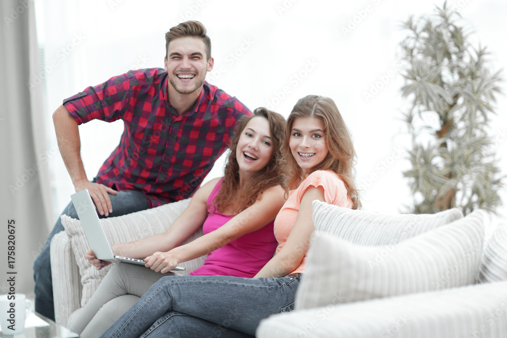 portrait of a group of young people sitting on the couch in the living room. portrait of a group of young people sitting on the couch in the living room.
