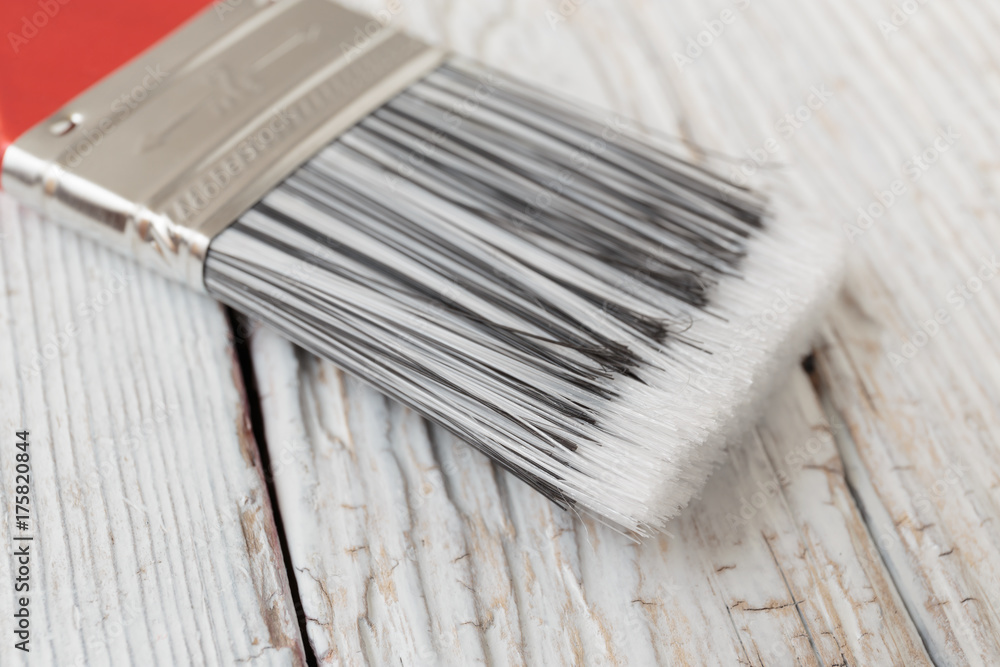 Paint brush on a white wooden board Paint brush on a white wooden board