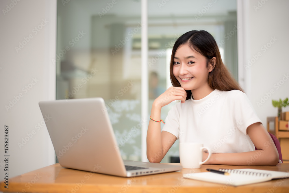Businesswoman working at home with laptop for surfing the internet for comercial. Online shopping business and Relax on holiday concept Businesswoman working at home with laptop for surfing the internet for comercial. Online shopping business and Relax on holiday concept
