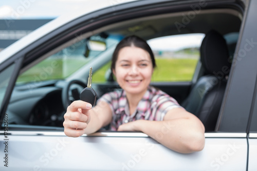Happy woman driver showing car keys