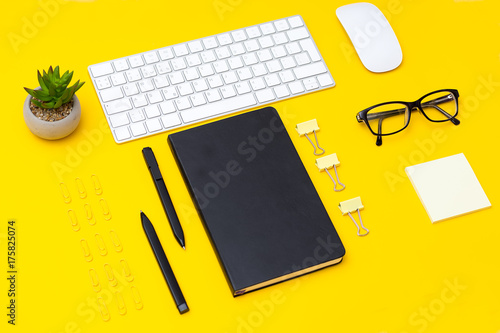 Stationery items on a yellow background. Geometric style