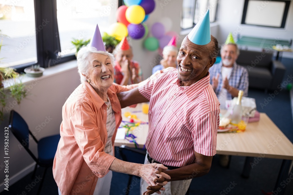 Obraz premium Portrait of happy senior couple dancing at party