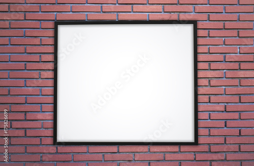 Brick wall and white screen or poster in a black frame