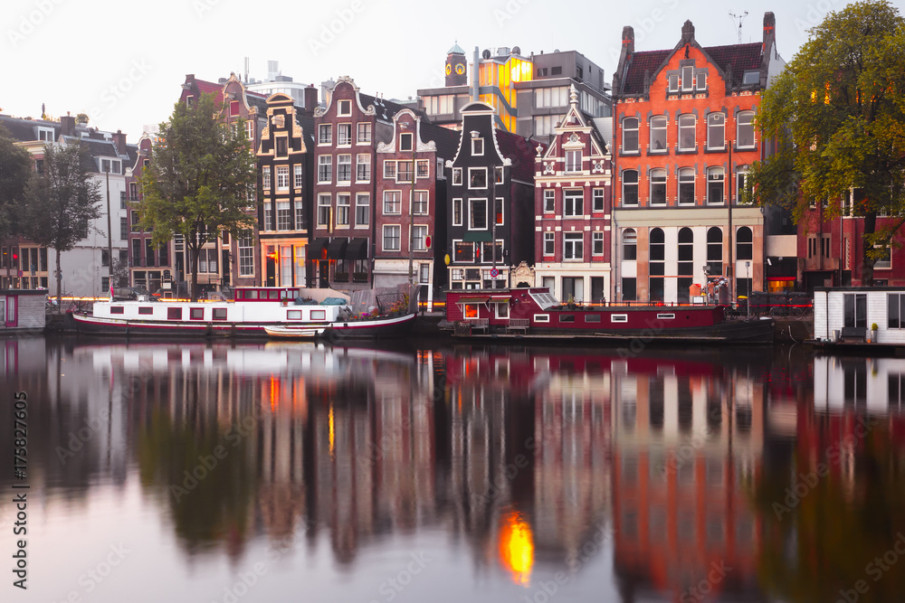 Amsterdam canal Amstel with typical dutch houses and houseboat from the boat in the morning, Holland, Netherlands. Amsterdam canal Amstel with typical dutch houses and houseboat from the boat in the morning, Holland, Netherlands.