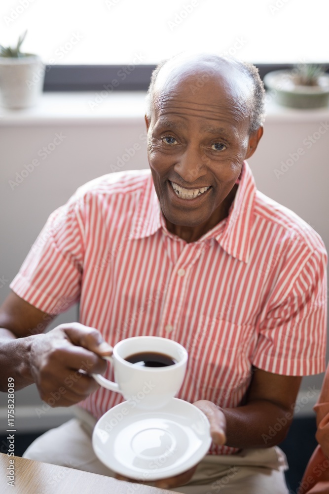 High angle portrait of smiling senior man having coffee High angle portrait of smiling senior man having coffee