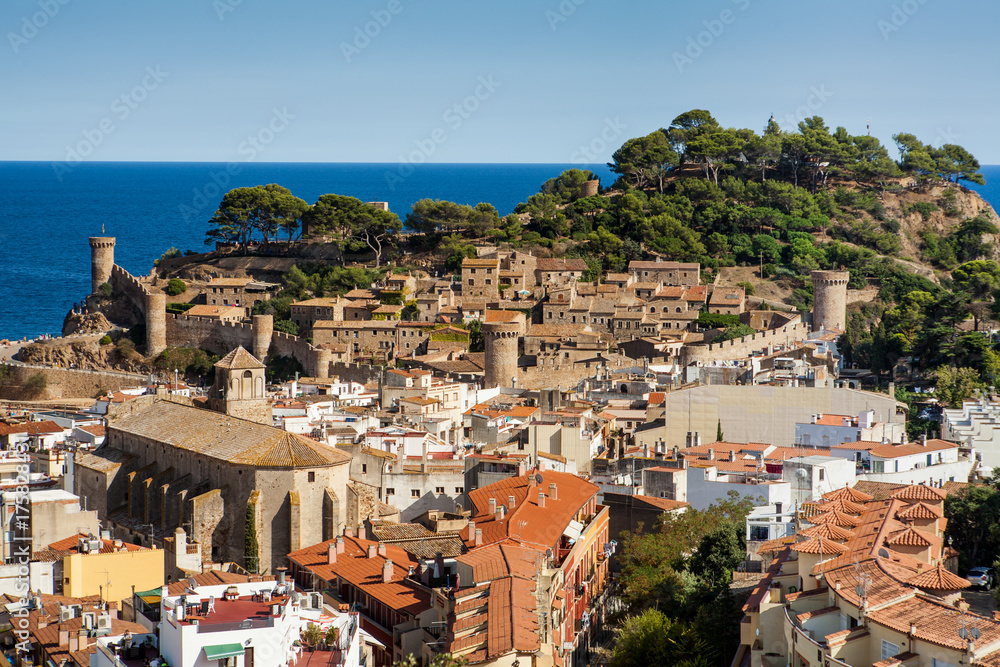 Top view of the town and castle in Tossa de mar, city on the Costa Brava. Buildings and hotels by the beach. Amazing city in Girona, sea and moored boats in Catalonia. City and see.