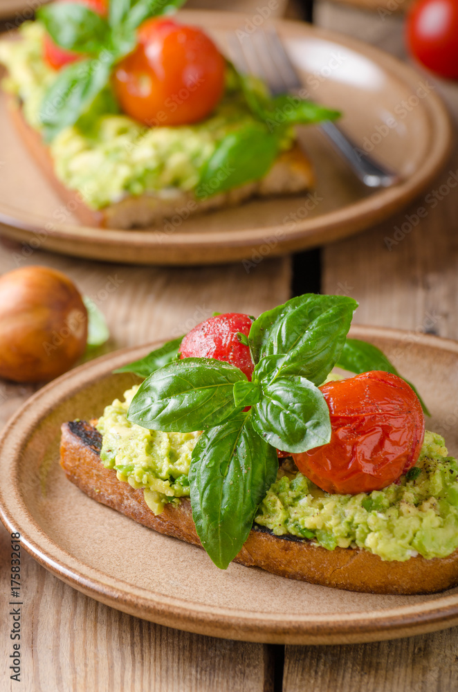 Avocado spread bread with baked tomato Avocado spread bread with baked tomato