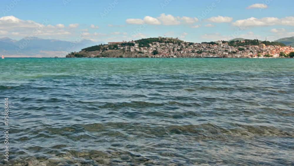 Ohrid, Macedonia - 03 July 2017: Ohrid Lake and the beaches around the lake with the background scene of Ohrid Town Ohrid, Macedonia - 03 July 2017: Ohrid Lake and the beaches around the lake with the background scene of Ohrid Town