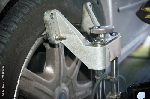 detail of wheel alignment machine tool mounted on a wheel © daniele russo