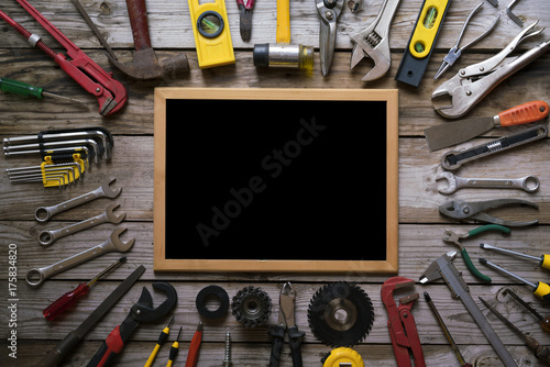 Old tools equipment with blackboard on wood table background, engineering concept