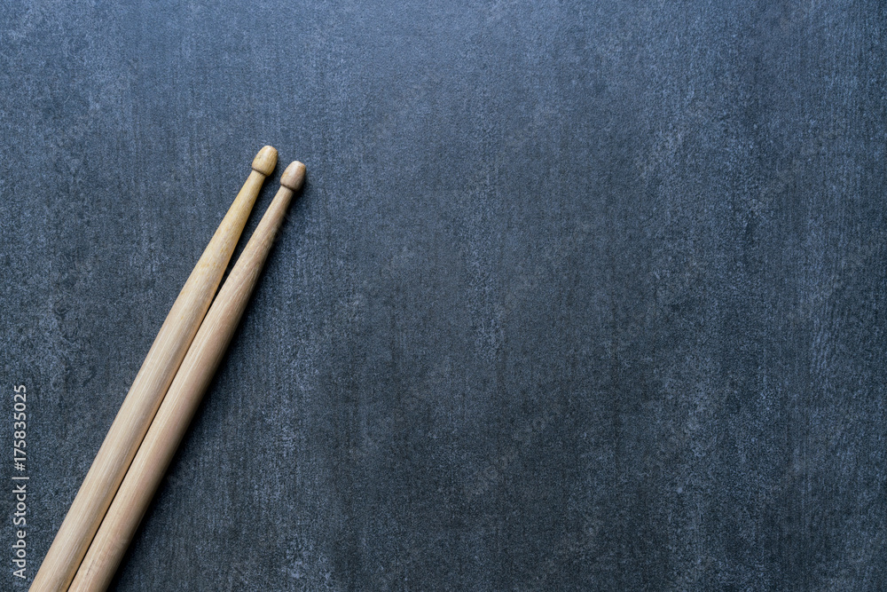 Obraz premium Drum stick on black table background, top view, music concept